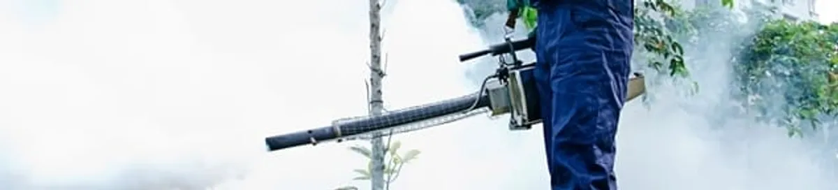Pest control technician fogging an outdoor area for insect control in Charlotte, NC
